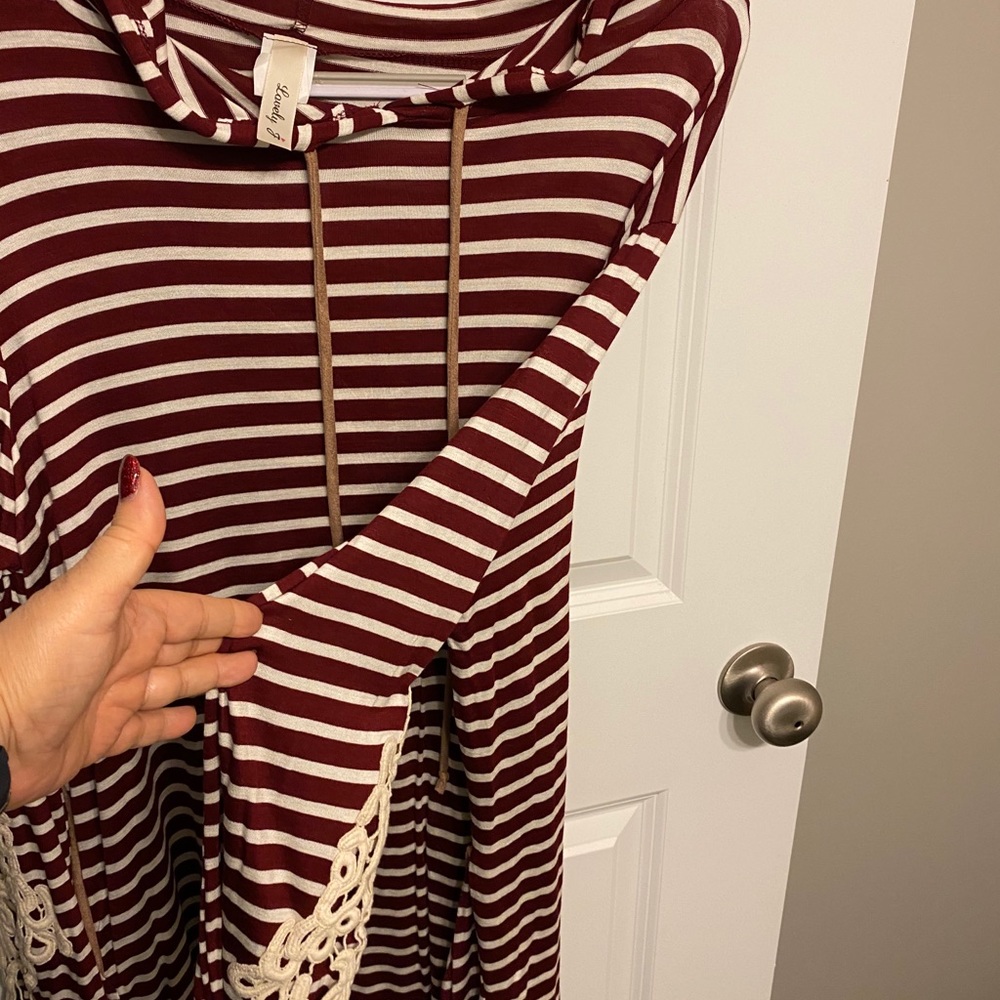 Long sleeve top with lace detail on sleeve.